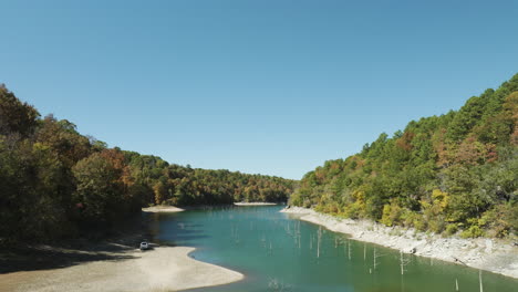 beaver lake with wood pilings during fall season in arkansas, usa