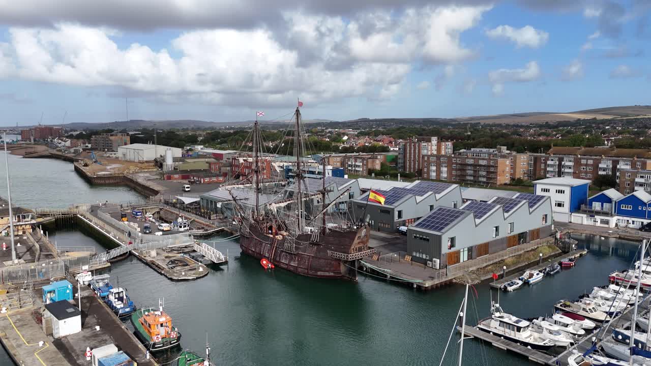 Aerial cinematic view of Galeón Andalucía, a stunning replica Spanish galleon docked at Shoreham Harbour. Unique historic tall ship, perfect for travel, heritage, and nautical footage