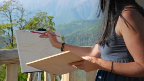 artist painting mountain landscape