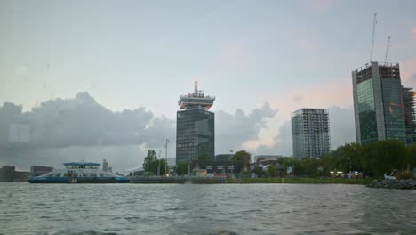 a view of adam tower seen from the ij river on amsterdam downtown in netherlands