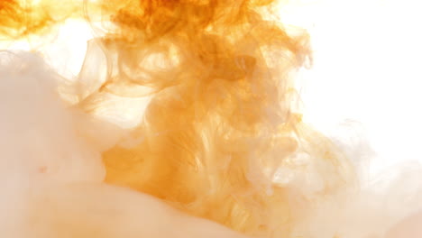 abstract light tea coloured fluid slowly mixing together