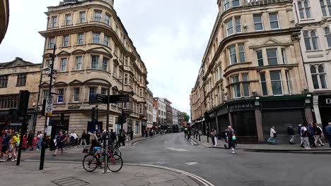 people walking and cycling on a busy street