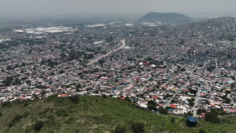 Aerial-view-overlooking-the-Ecatepec-de-Morelos-favela,-in-Mexico---circling,-drone-shot