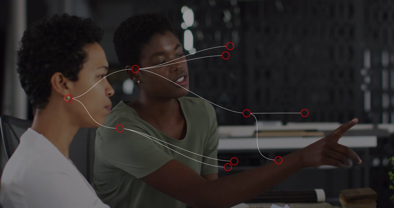 Animation of network of connections over diverse businesswomen talking in office