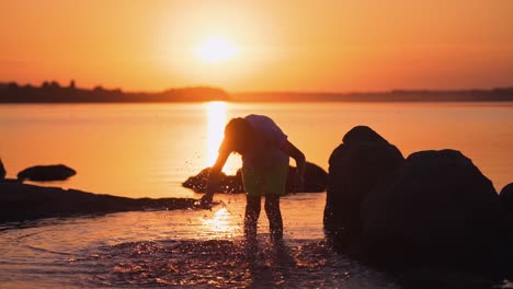 boy near water pond. silhouette of boy enjoying life near the pond