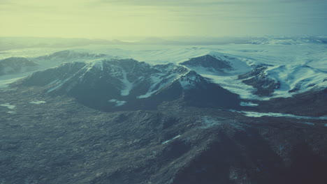 large-snow-patch-left-over-on-the-volcanic-rock-field-of-a-mountain-in-summer