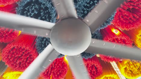 un ventilador de techo gira sobre una decoración colorida y texturizada, creando una atmósfera dinámica y animada en un espacio interior moderno