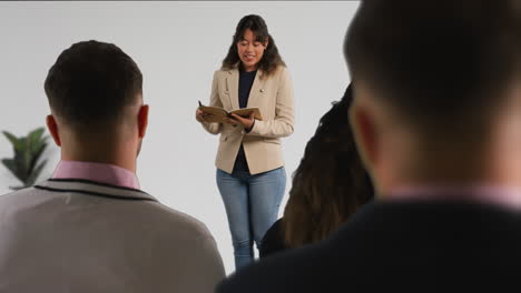 businesswoman or female college teacher giving presentation or lesson in office or classroom 1