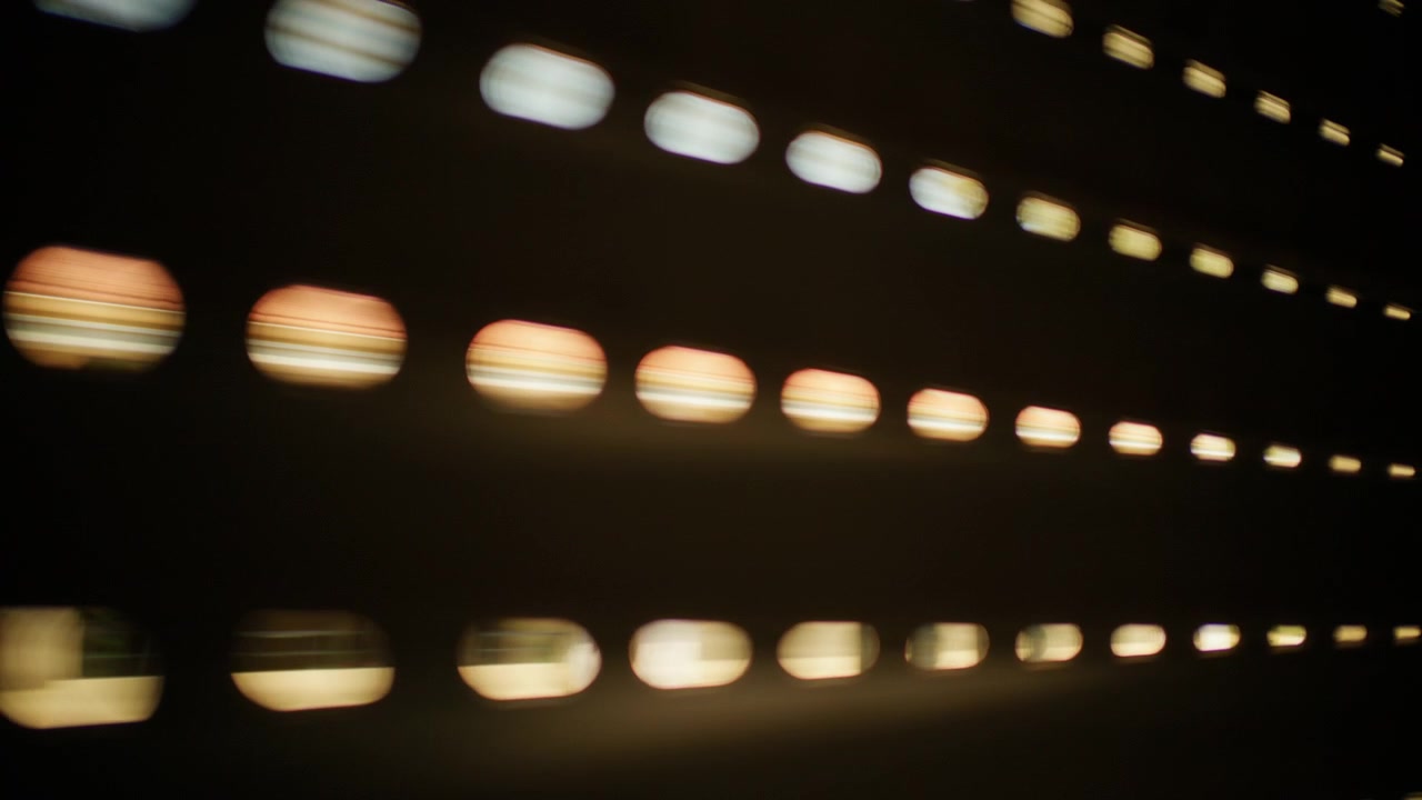Blurred circular light spots forming an abstract pattern against a dark background, evoking motion and digital technology