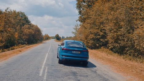 presentation of a blue audi e-tron, compact luxury crossover suv. modern new cars for sale