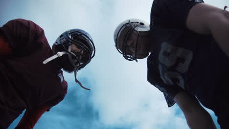 american football players facing each other, seen from a low angle