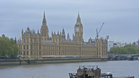 Westminster-Palace-and-Big-Ben-clock-tower-with-Thames-river-in-foreground,-London-in-UK