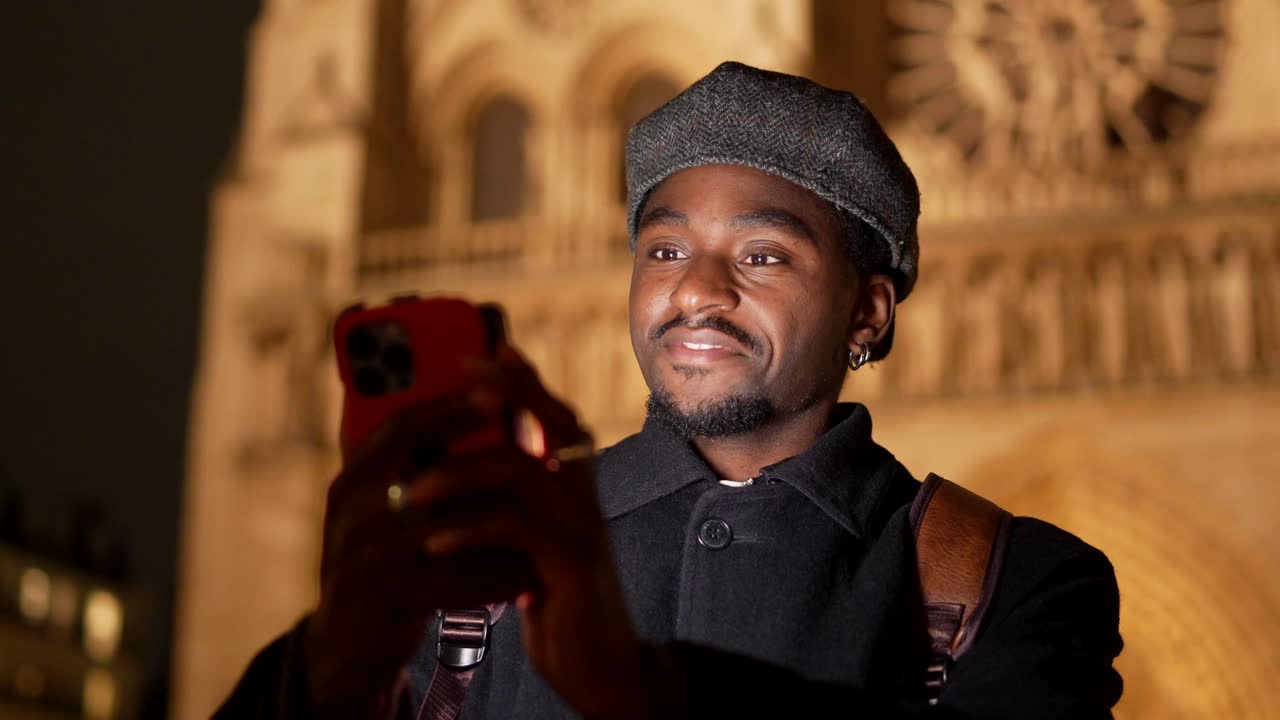 Man taking a photo with his smartphone at night in the city