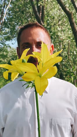 man with yellow lilies