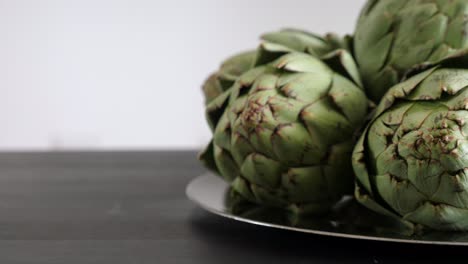 close-up of fresh artichokes on a plate