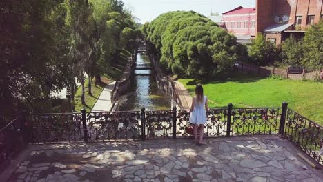 canal view with love locks and woman in white dress