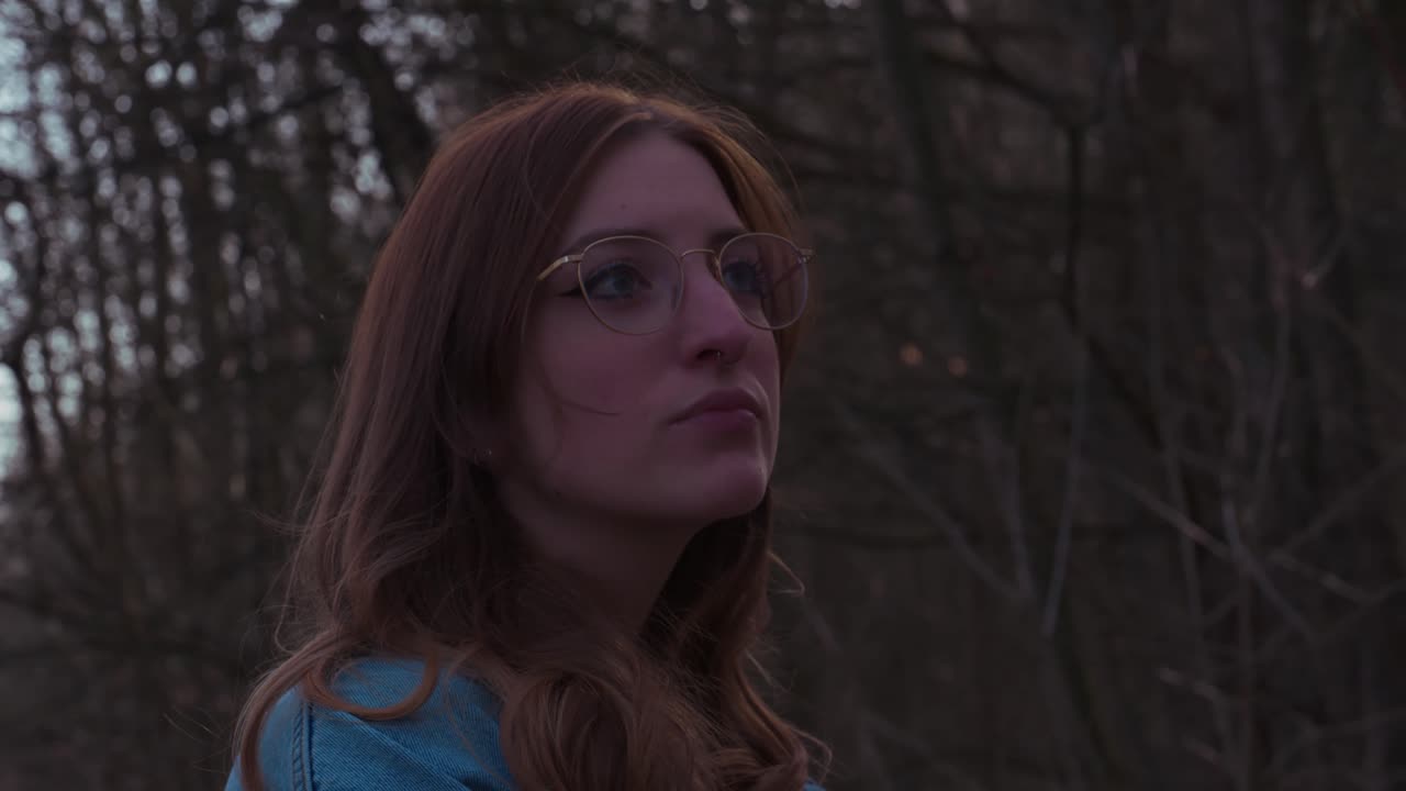 Girl in a Forrest thinking and beeing anxious