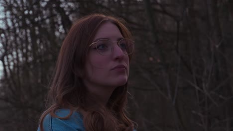 girl in a forrest thinking and beeing anxious