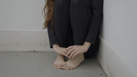 Woman sitting alone in a corner