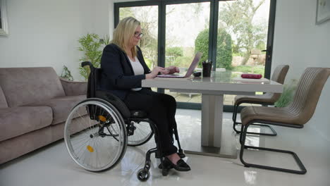 Woman-in-wheelchair-in-home-office-straight-on-camera-move