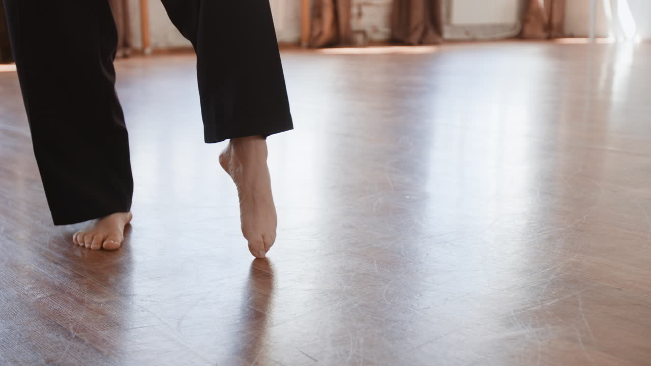 Bare Feet Practicing Dance Steps on a Wooden Studio Floor