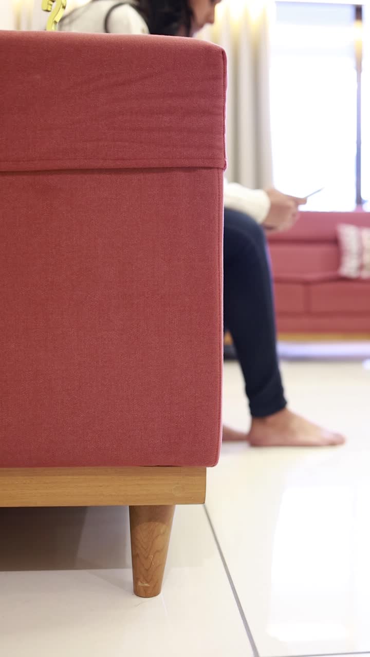 cinematic shot woman sitting a sofa at hall