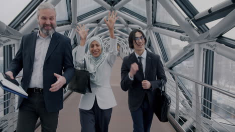 business colleagues walking through modern city bridge