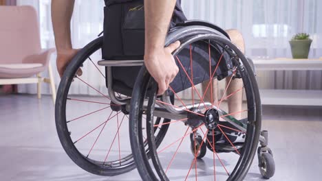 close-up of hands holding a wheelchair.