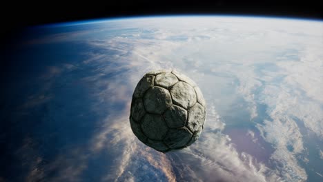 old soccer ball in space on earth orbit