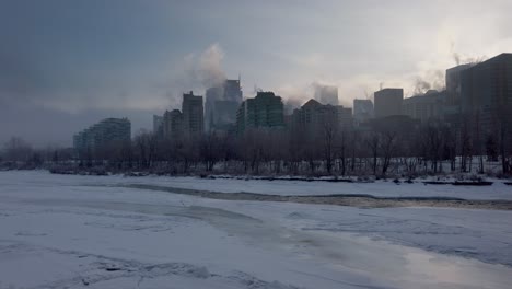 frozen river skyscrapers steaming downtown calgary pan