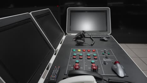 modern maritime university simulator control room with multiple monitors, control panels, communication devices, and navigation instruments for maritime training