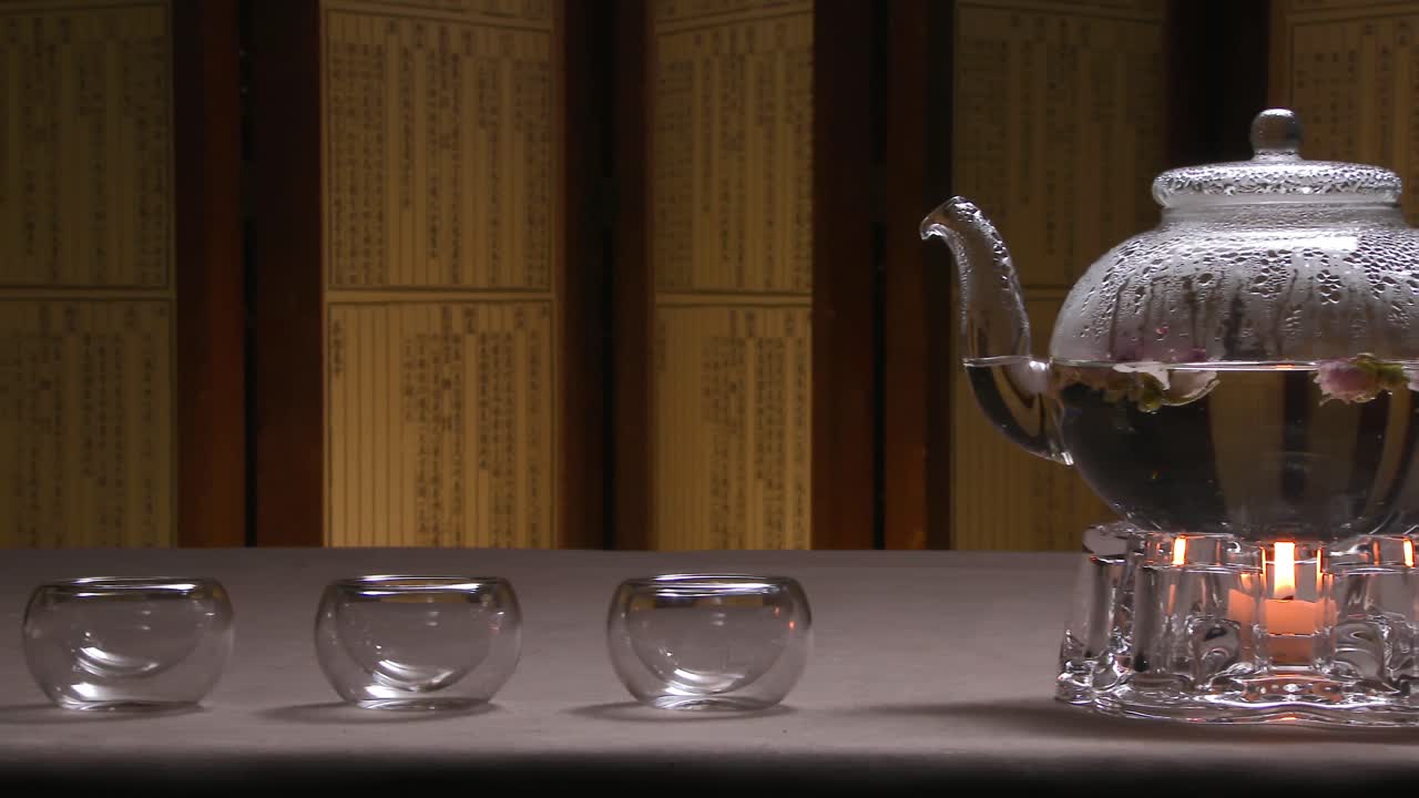 Glass Teapot with Rose Tea and Teacups