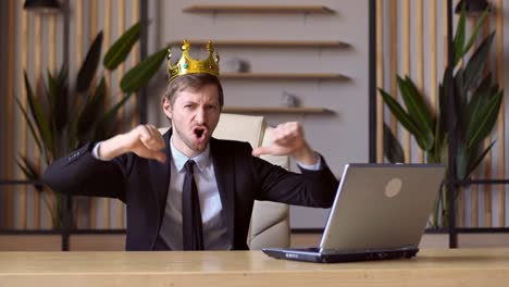 portrait of ambitious man wearing king crown and pointing himself, looking with arrogance.