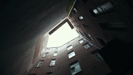 view of old building in tight yard. natural daylight. cloudy weather. looking up