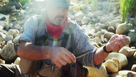 fly fisherman putting new string on fishing rod