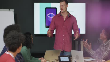 Happy-diverse-business-people-discussing-work-during-meeting-at-office