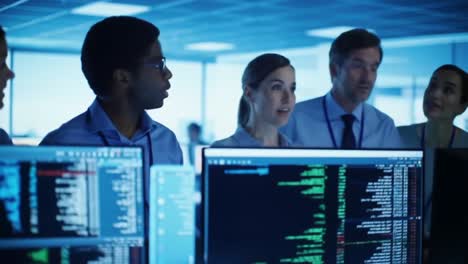 a diverse team collaborates in a dynamic office environment, analyzing complex data on multiple screens while engaging in collaborative discussion and problem solving