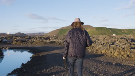 unrecognizable woman photographer visiting blue lagoon, iceland