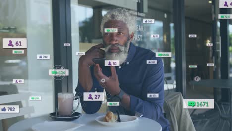 Animation-Von-Social-Media-Symbolen-Und-Zahlen-über-Einem-Afroamerikanischen-Mann,-Der-Sein-Smartphone-Nutzt