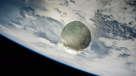 old soccer ball in space on earth orbit