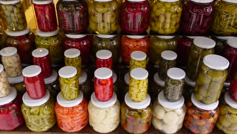 assortment of pickled vegetables in jars at a turkish market