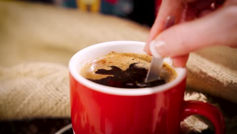 Woman's-hand-stirring-cup-of-coffee-4K-Slow-Motion