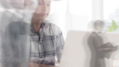 Animation-of-busy-people-walking-over-caucasian-businesswoman-in-office