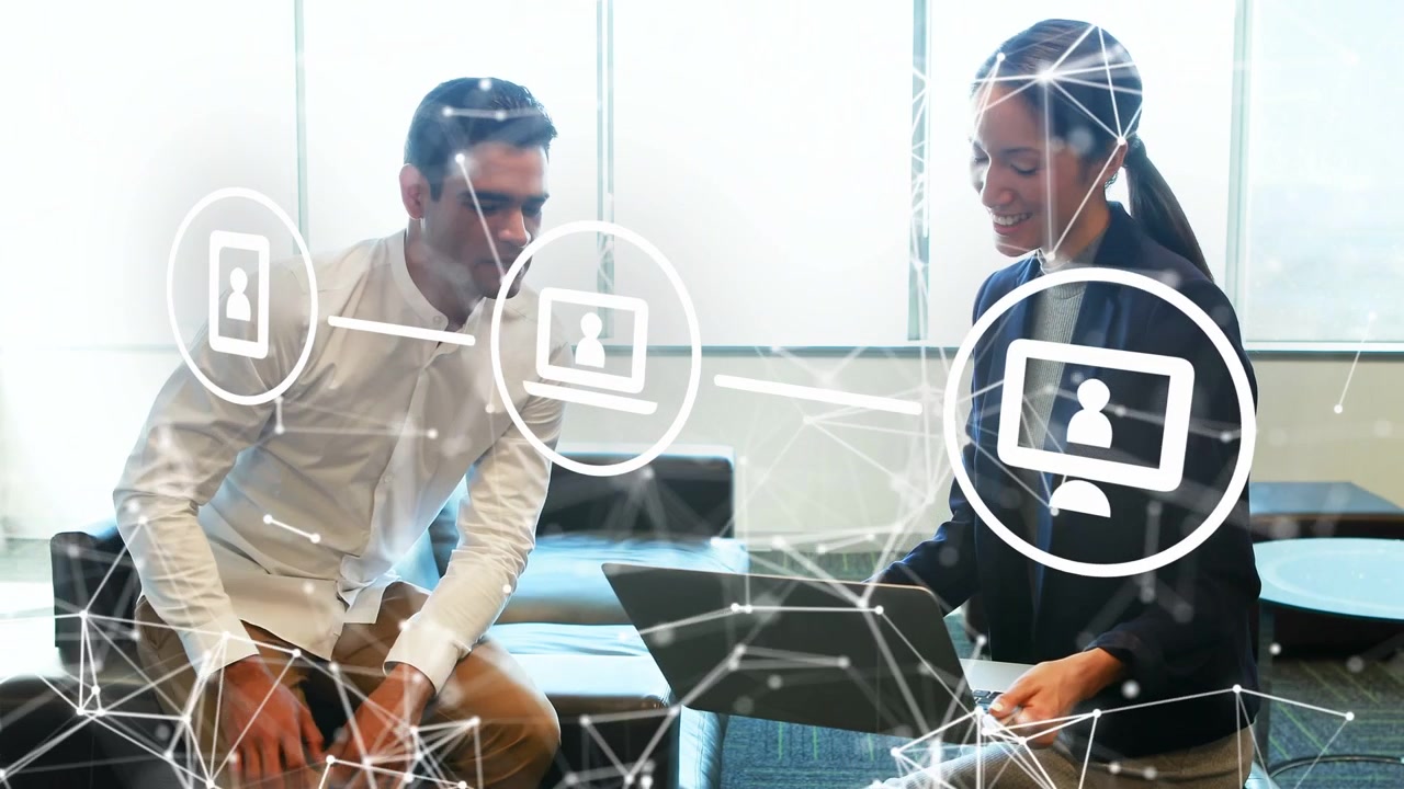 Woman angling laptop while man leaning in nodding, network overlay linking for office tech demo