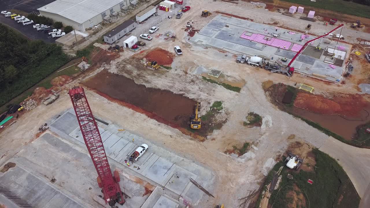 descending aerial view of construction crane