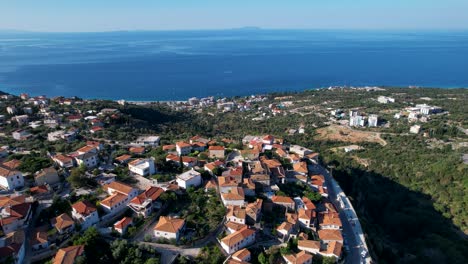 blue sea and green hills with touristic villages on albanian riviera, famous location for summer vacation in mediterranean, great opportunity for real estate