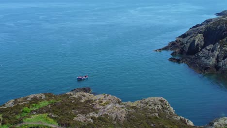 boat fishing on amlwch anglesey north wales rugged mountain coastal walk aerial view zoom in