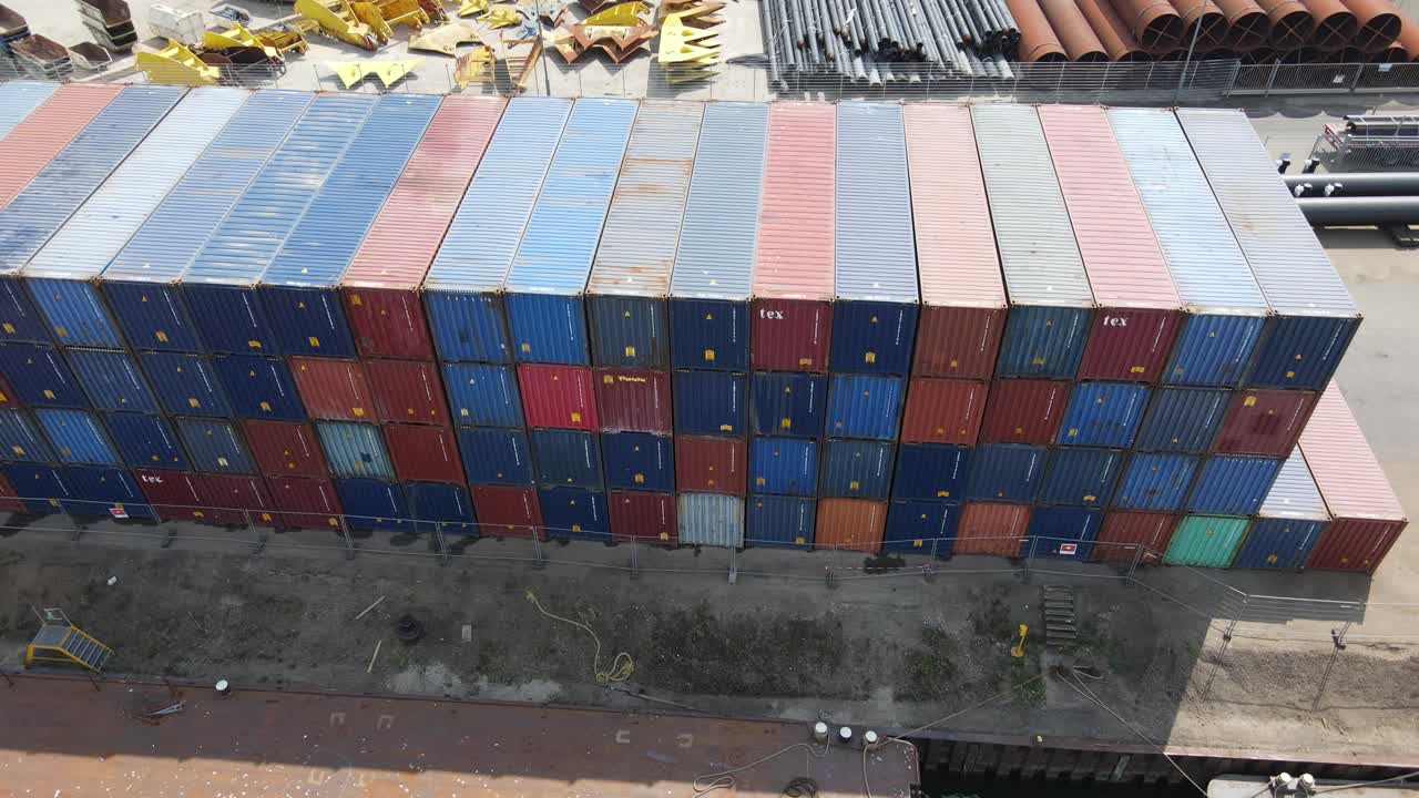 Stack Of Cargo Containers In An Open Logistic Terminal. Port Of Dordrecht In Netherlands. aerial sideways