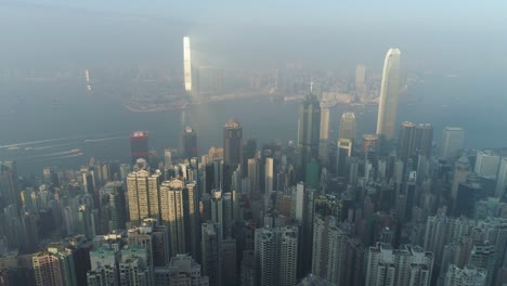 hong kong skyline and victoria harbour. aerial view. drone is flying sideways fast. establishing shot.