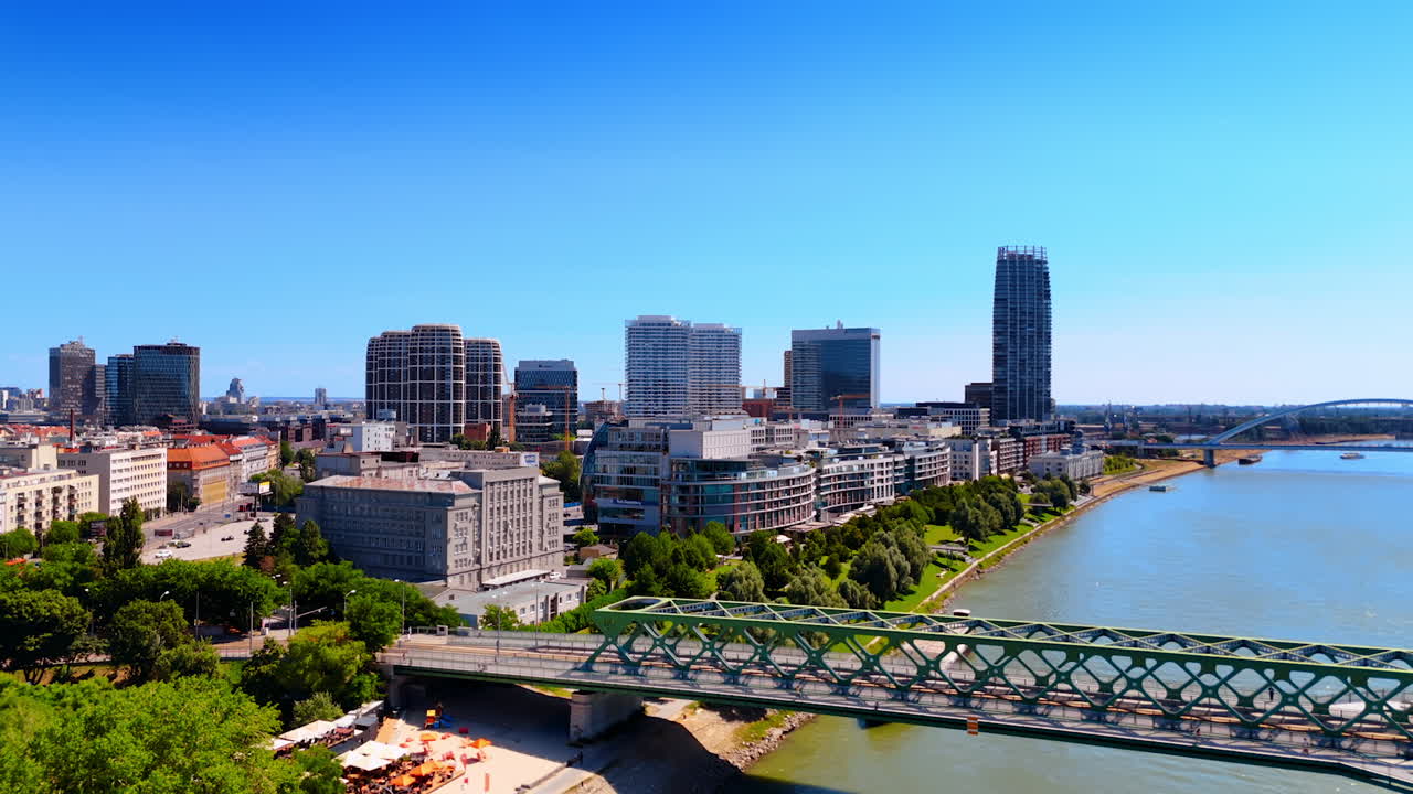 Approaching the entrance to the Old Bridge over the Danube River in Bratislava, Slovakia. Modern high-rises in the cityscape at backdrop